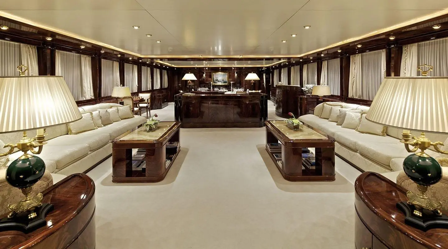 Luxurious yacht salon interior with beige seating, wood accents, and soft lighting