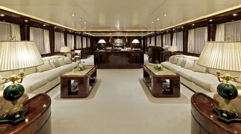 Luxurious yacht salon interior with beige seating, wood accents, and soft lighting