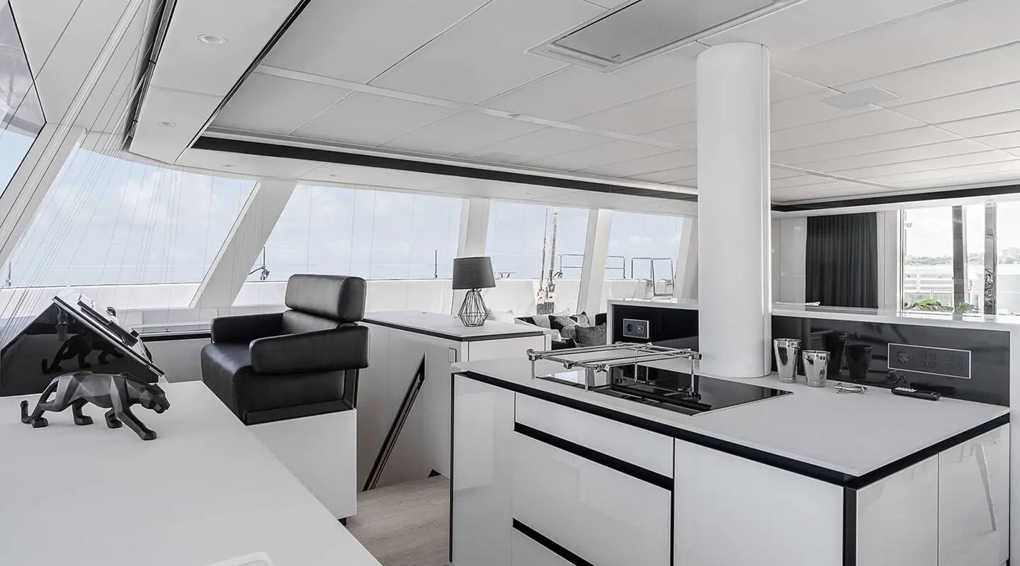 Interior of gulet Above & Beyond yacht saloon with white cabinetry and seating