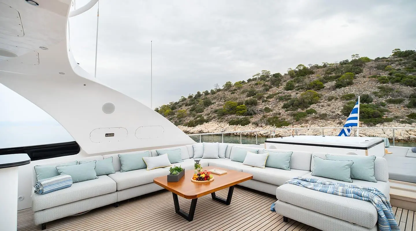 Pareaki II exterior deck with light blue cushioned seating and a wooden table