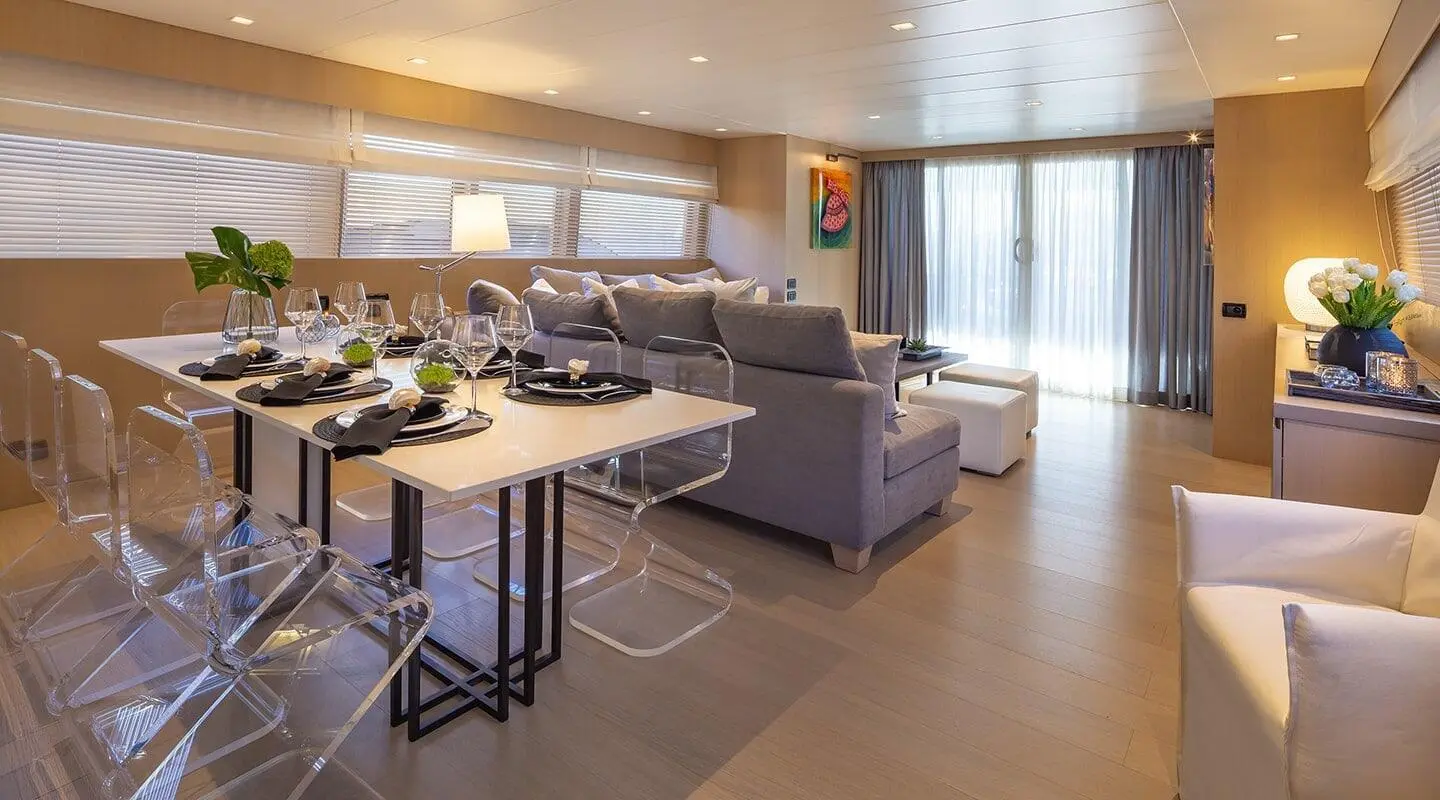 Interior of Summer Fun motoryacht salon with seating, table, and windows