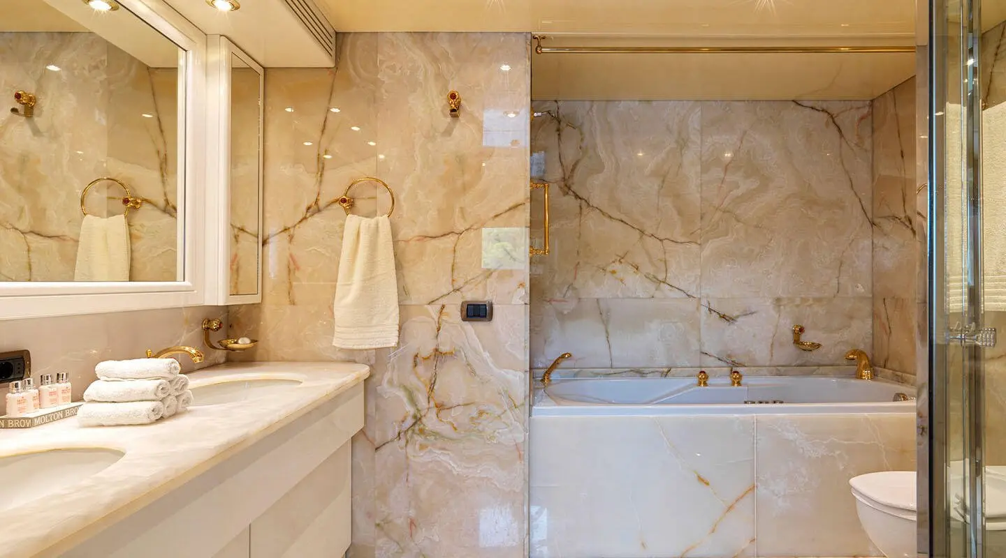 Idylle motor yacht master ensuite bathroom with marble walls and fixtures