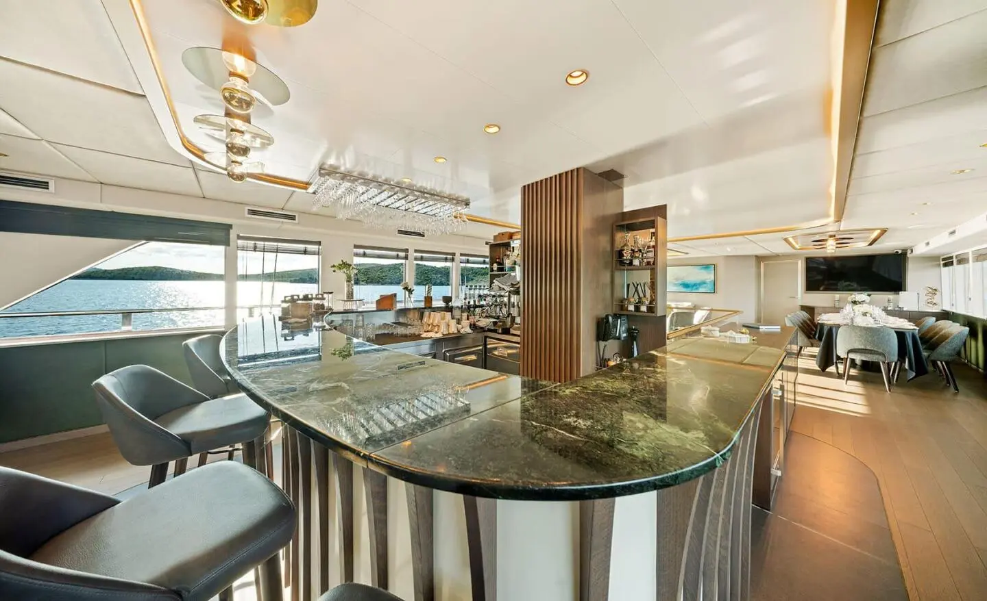 Anima Maris yacht exterior deck with seating, outdoor bar, and glass railing