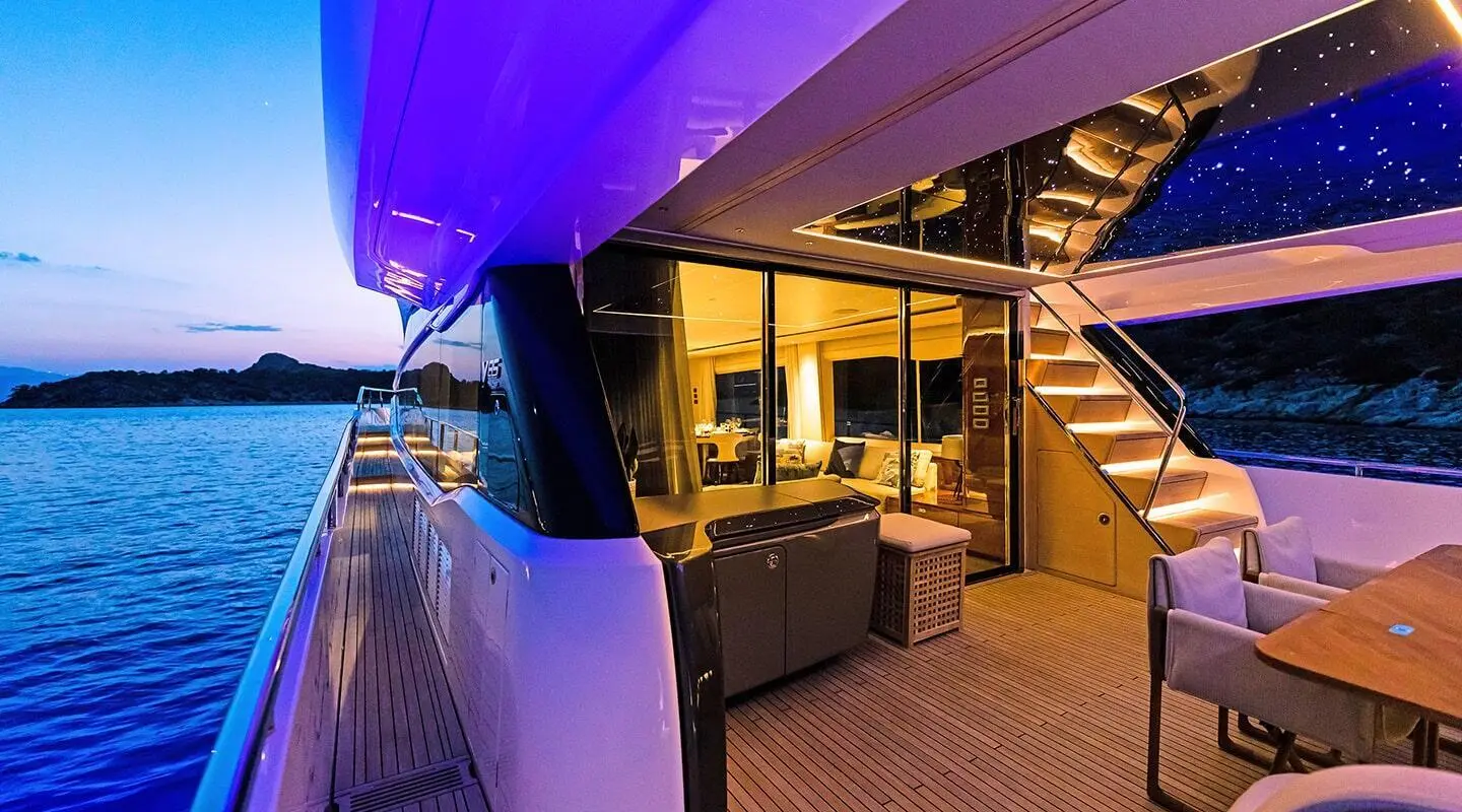 Vista yacht aft deck with seating, purple lighting, and open teak area