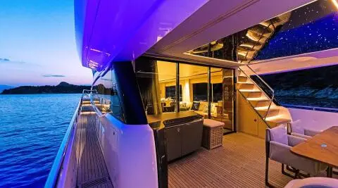 Vista yacht aft deck with seating, purple lighting, and open teak area