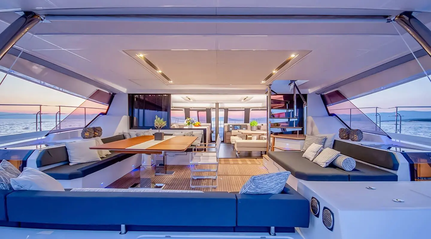 Yacht D2 aft deck with seating and sun pads under shaded area