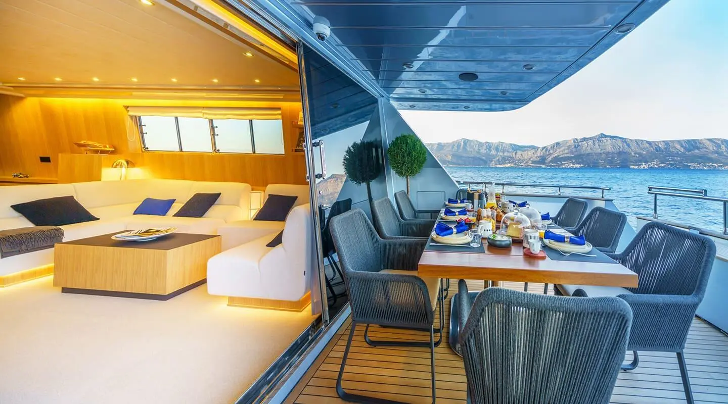 Interior of Phantom yacht with an outdoor dining table on the deck