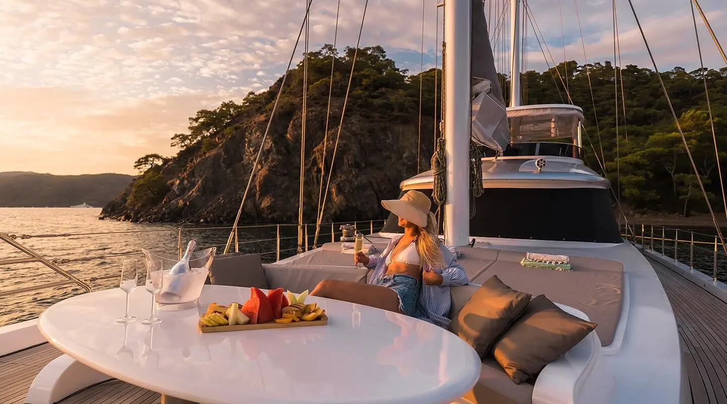 Angelo III gulet bow deck with a person lounging and a table setup