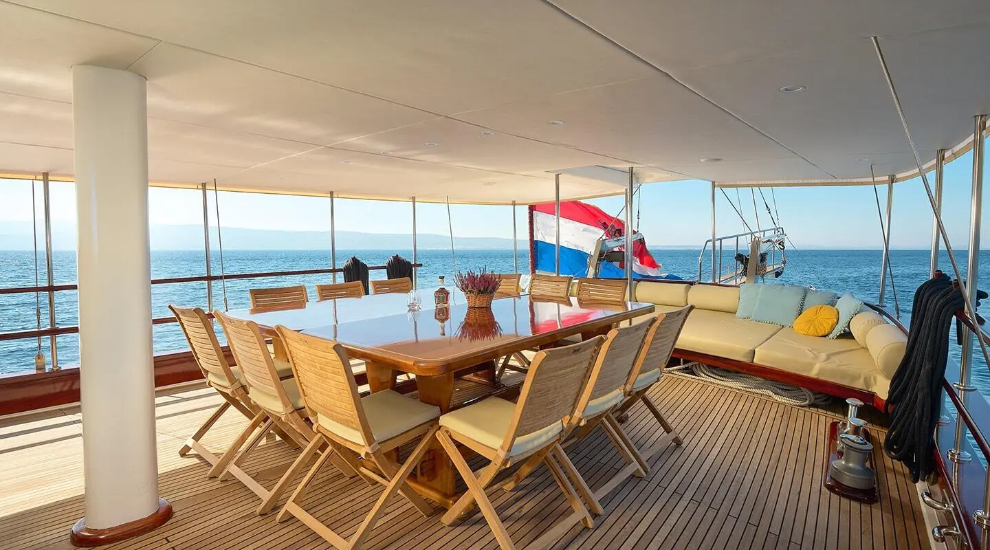 Linda yacht deck with wooden chairs at sunset, sea view, Turkish flag