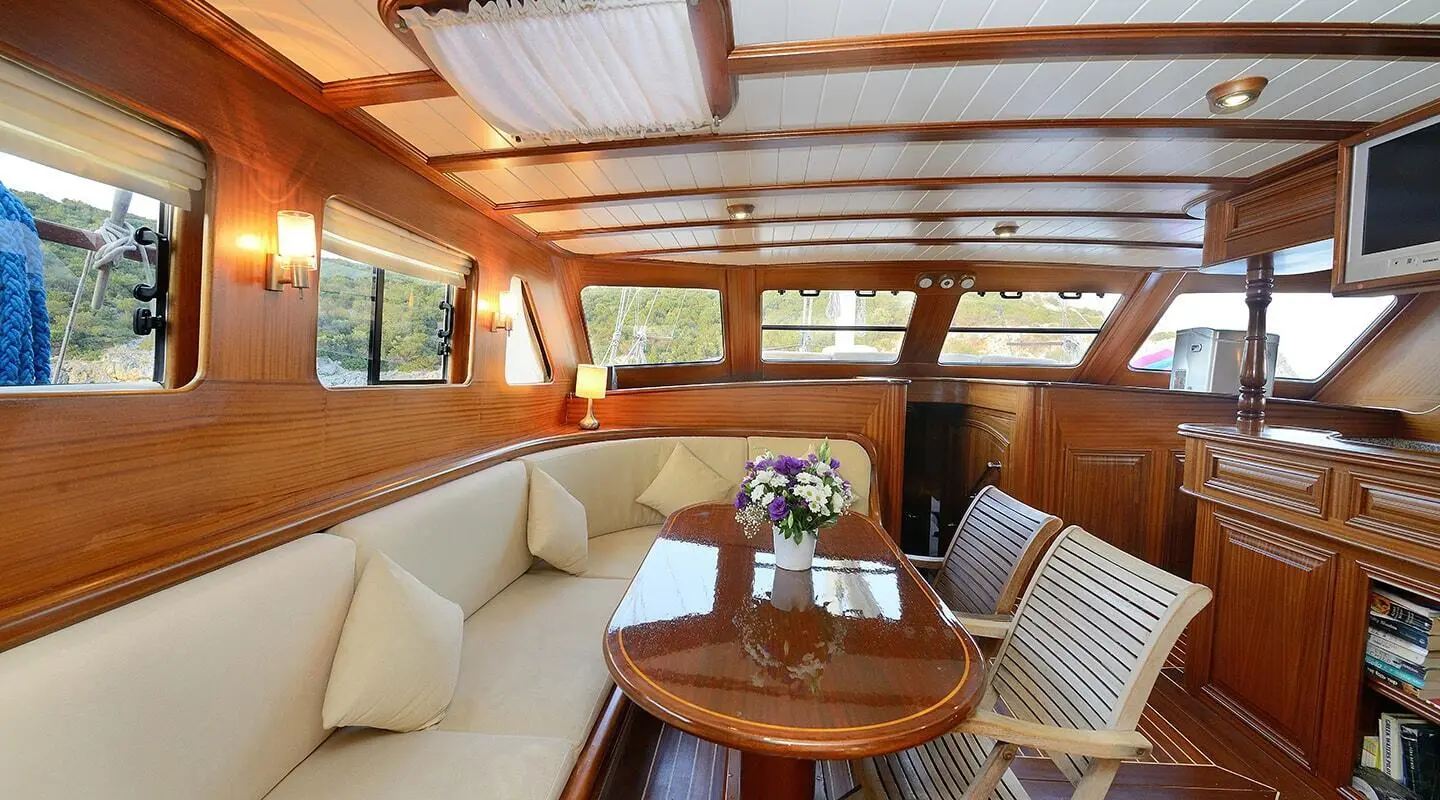 Samarkand yacht deck seating area under a wooden canopy at sunset