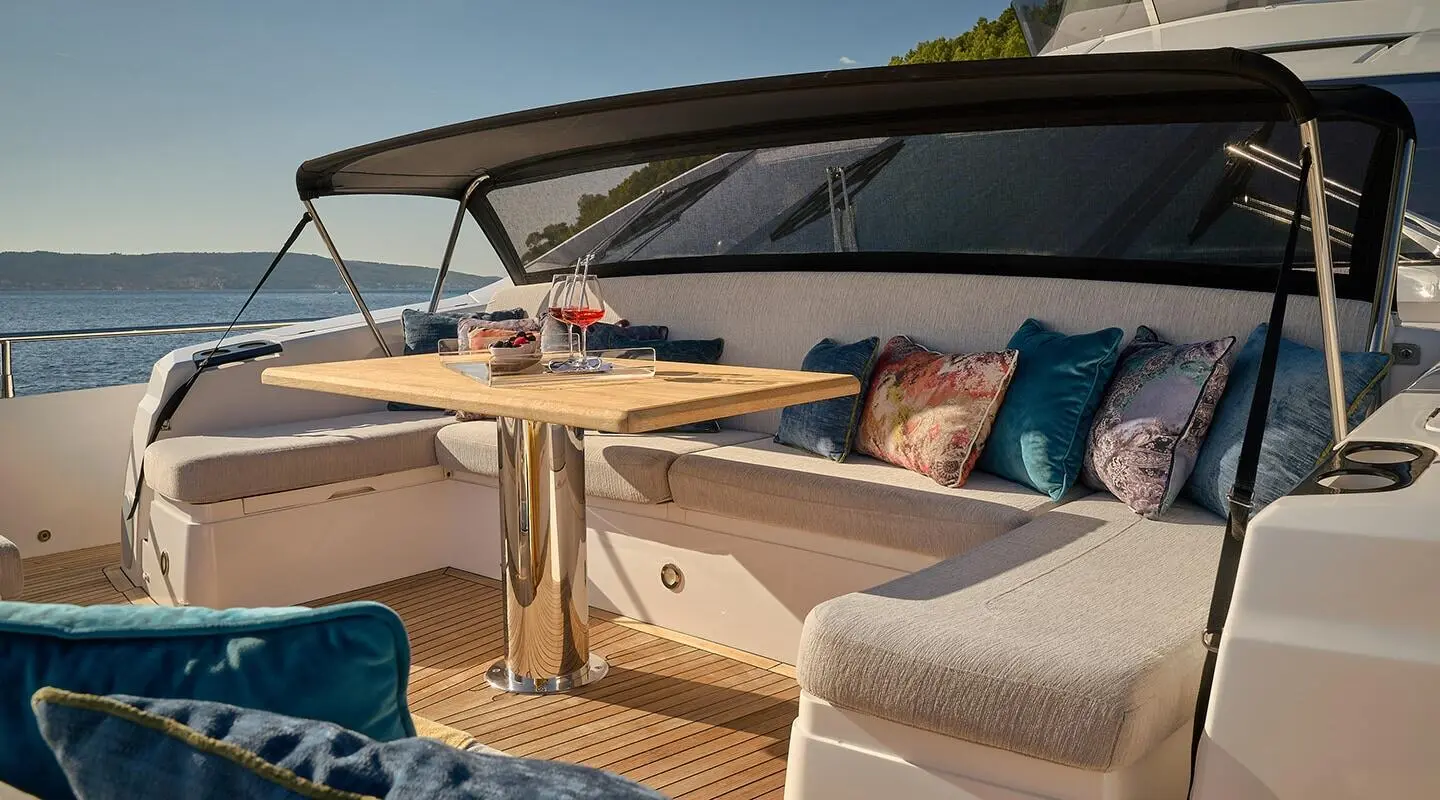 Yacht Hideaway deck seating and table at sunset on luxury mooring