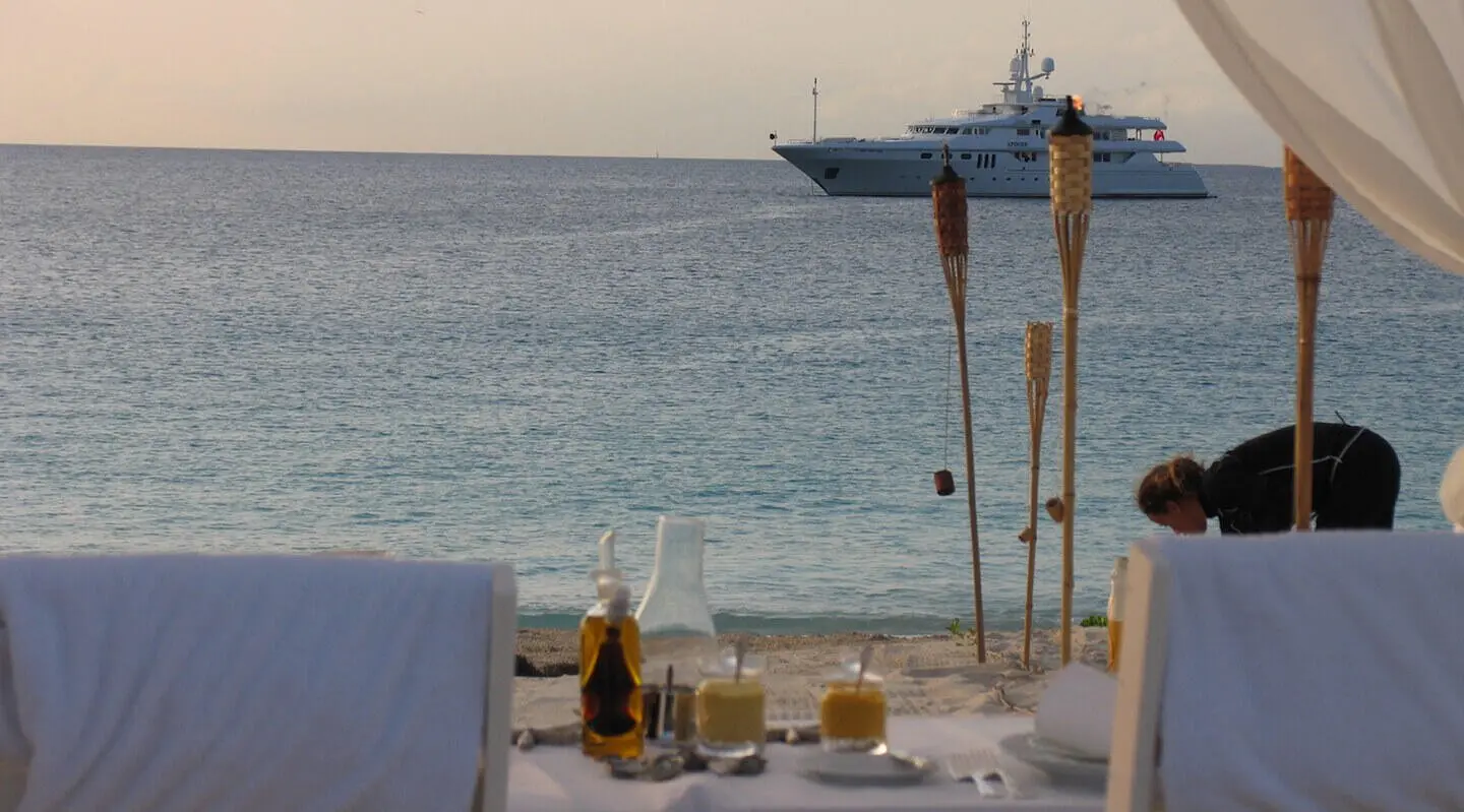 Sunset view from the Apogee yacht deck with table setup and sea