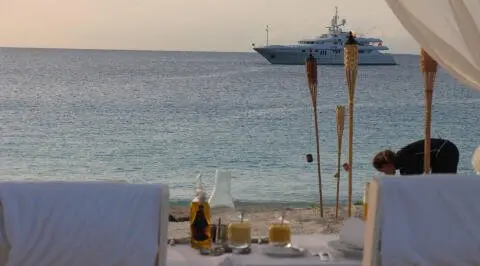 Sunset view from the Apogee yacht deck with table setup and sea