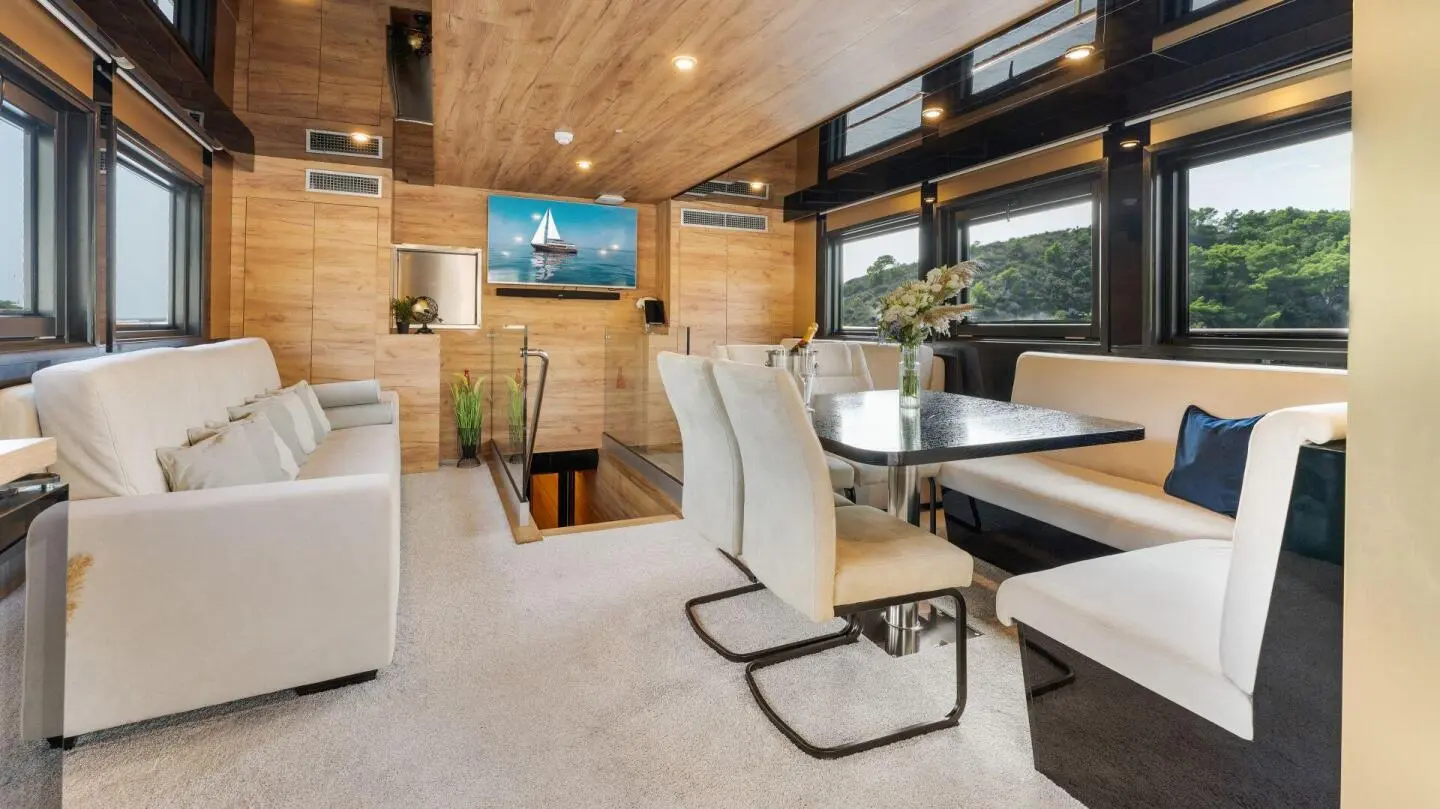 Interior salon of Santa Clara motor yacht with seating, table, and TV