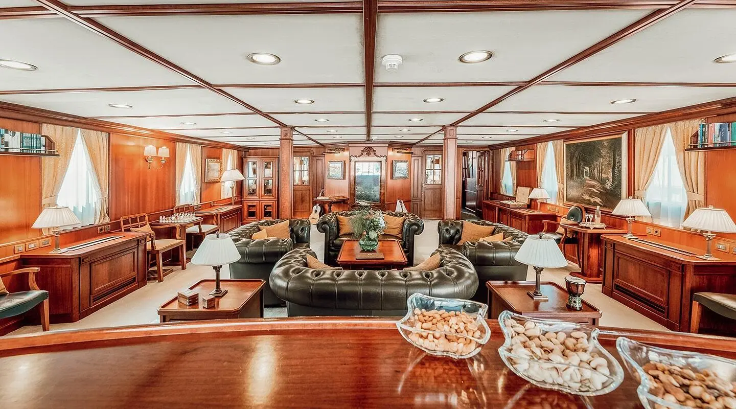 Interior of Seagull II yacht salon with wood paneling, seating, and table