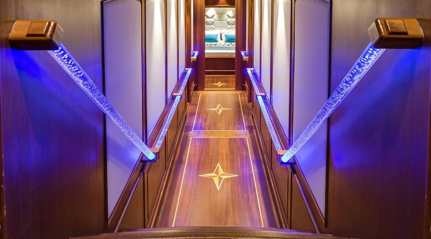 Interior corridor of a luxury yacht at dusk with polished wooden floor