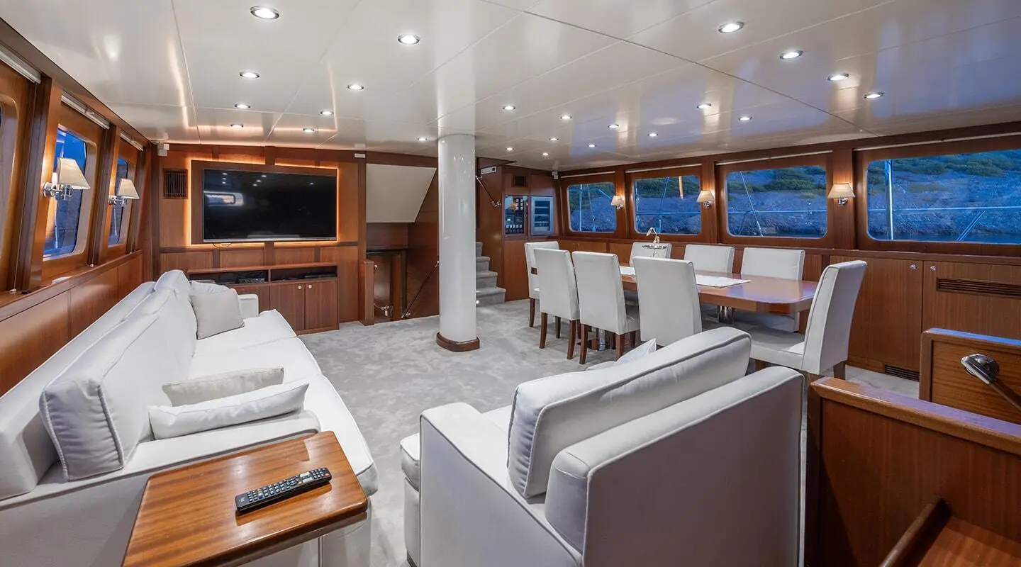 Interior of luxury gulet Lucky You with white seating, wooden accents, and ceiling lights