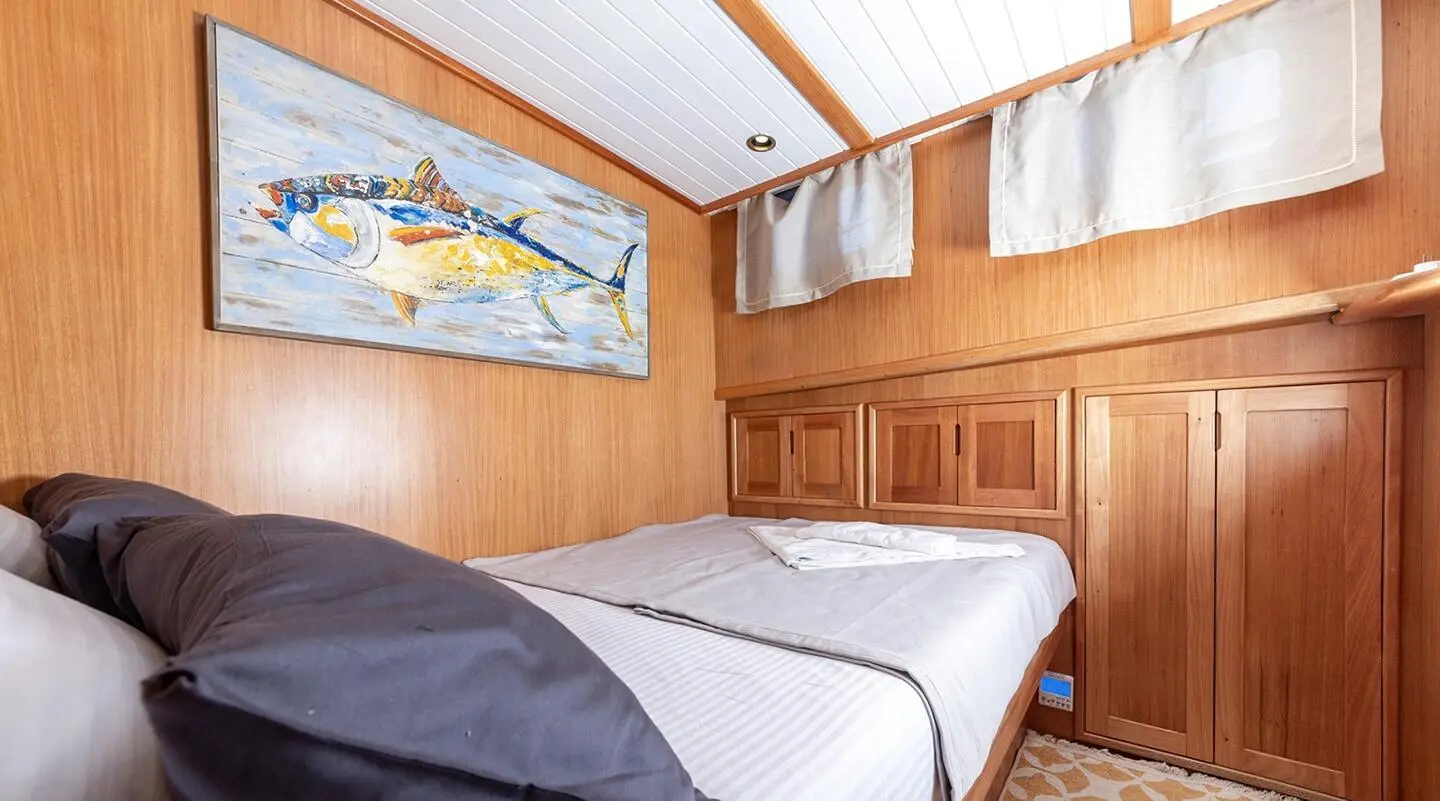 Interior bedroom on Bodrum Queen yacht with two single beds and wood paneling