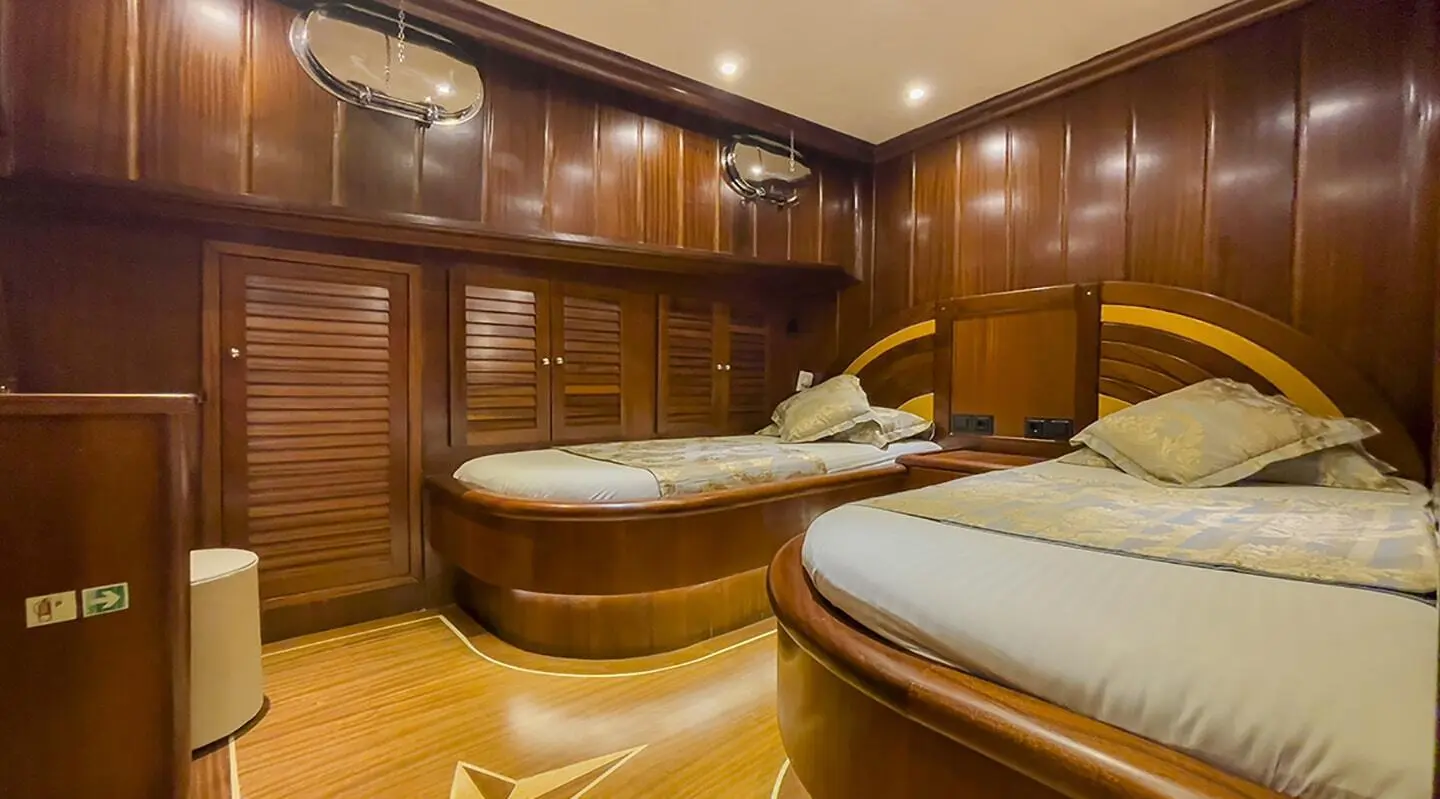 Luxury yacht Diva Deniz interior with polished wooden panels and round seating