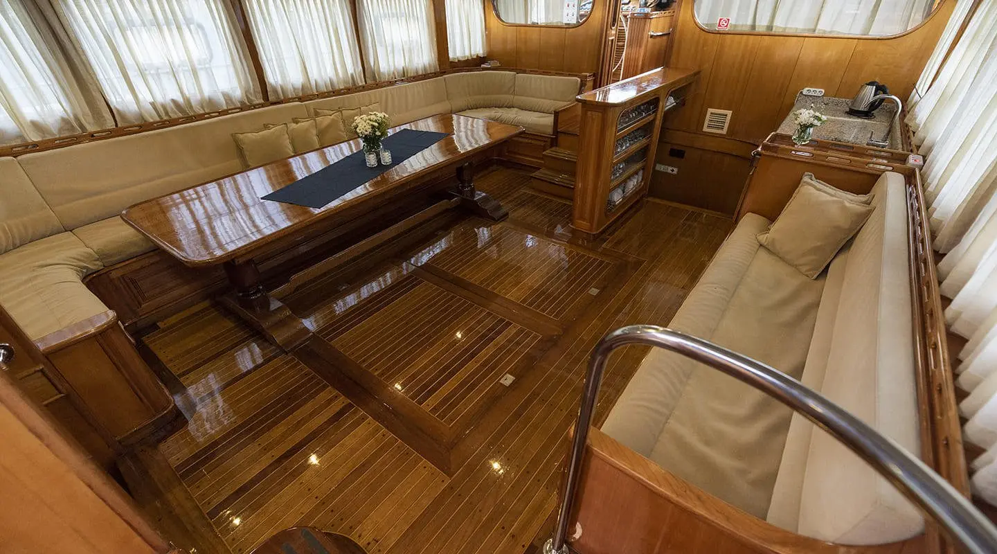 Kayhan 5 yacht interior: wood floors, seating, and saloon area with large windows