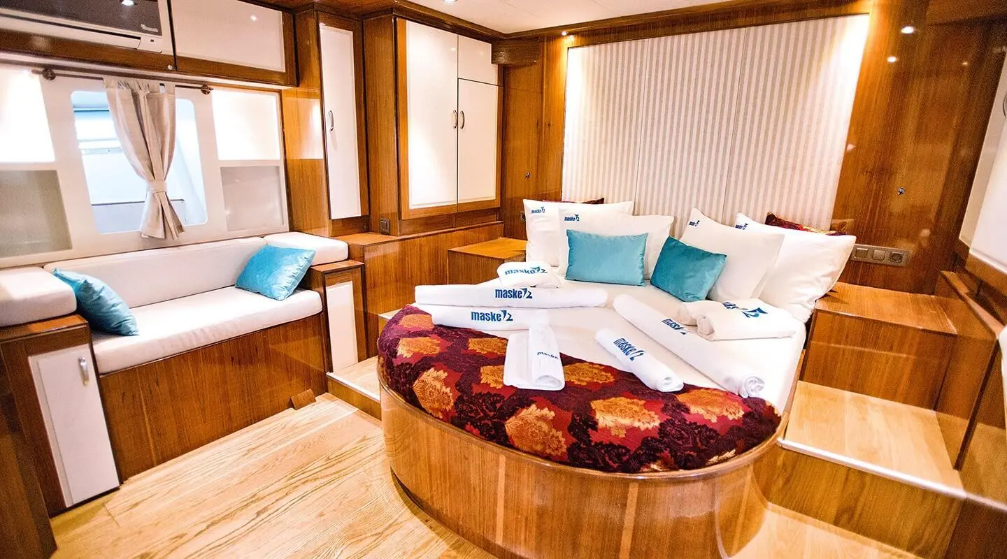 Maske 2 yacht: luxurious exterior deck with circular seating and cushions at sunset