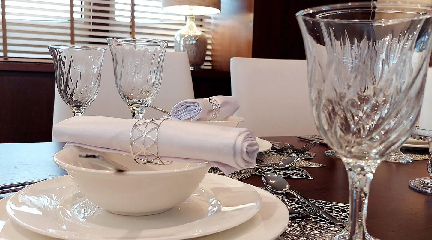 Table set for seashell wedding style on Miraval yacht, fine china and glassware