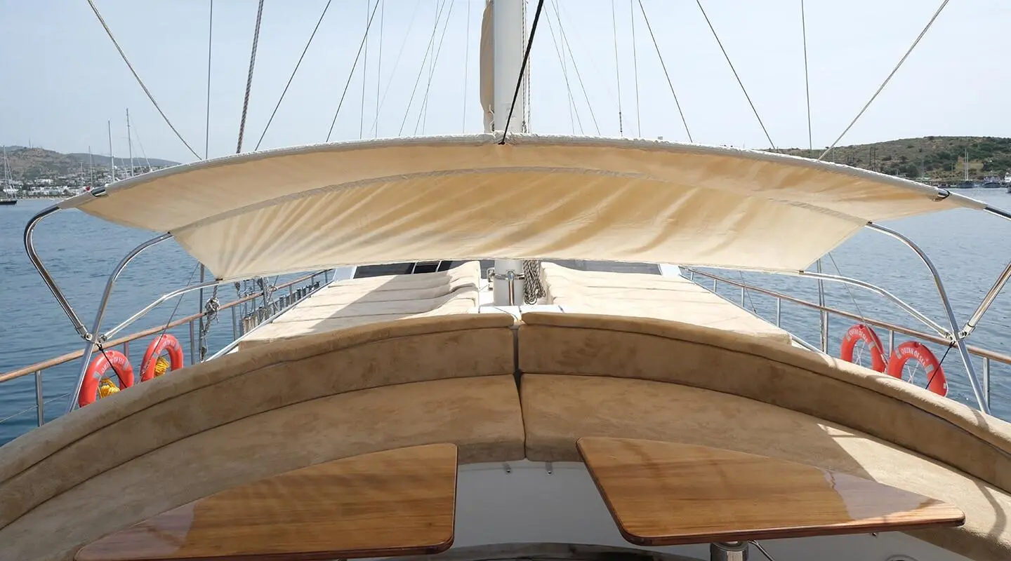 Bow deck of Queen Of Sea gulet with wooden planks and ropes visible