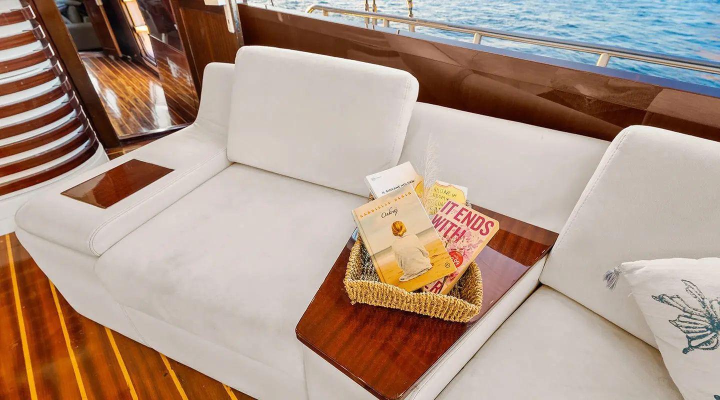 Esma Sultan yacht convertible sofa with a small table and snacks at sunset