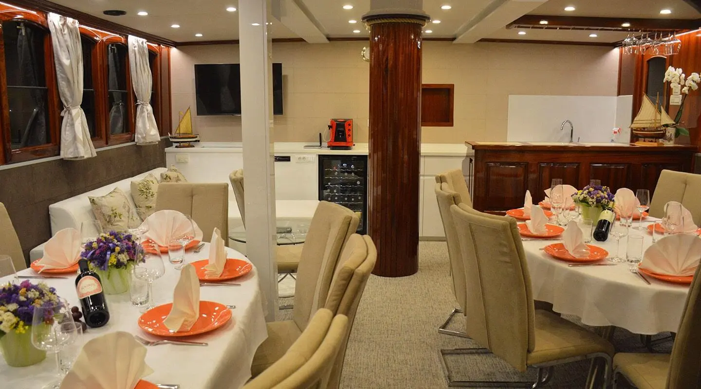 Tajna Mora luxury gulet sailing yacht interior with cream seats and table