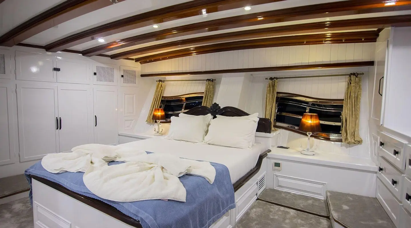 Grande Mare yacht interior deck seating with cushions and warm lighting at dusk