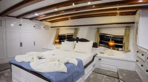 Grande Mare yacht interior deck seating with cushions and warm lighting at dusk