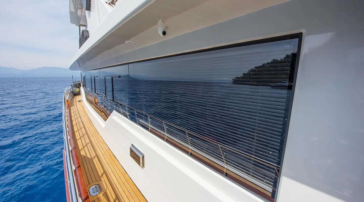 Side view of Simay M yacht with blue hull and deck on right side