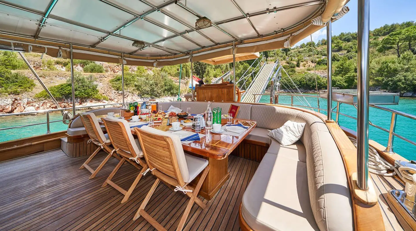 Gulet Libra dining area on the aft deck with seating and table settings
