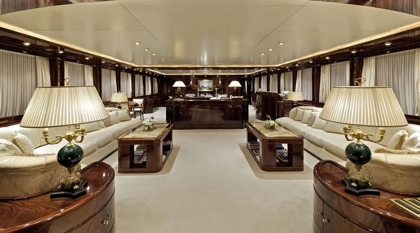 Luxurious interior of O'Rion yacht lounge with plush cream sofas and polished wood accents