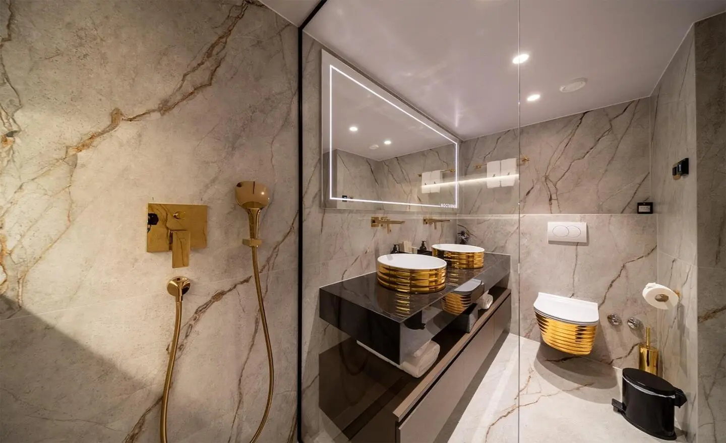Nocturno yacht bathroom with marble walls, glass shower, and wooden accents