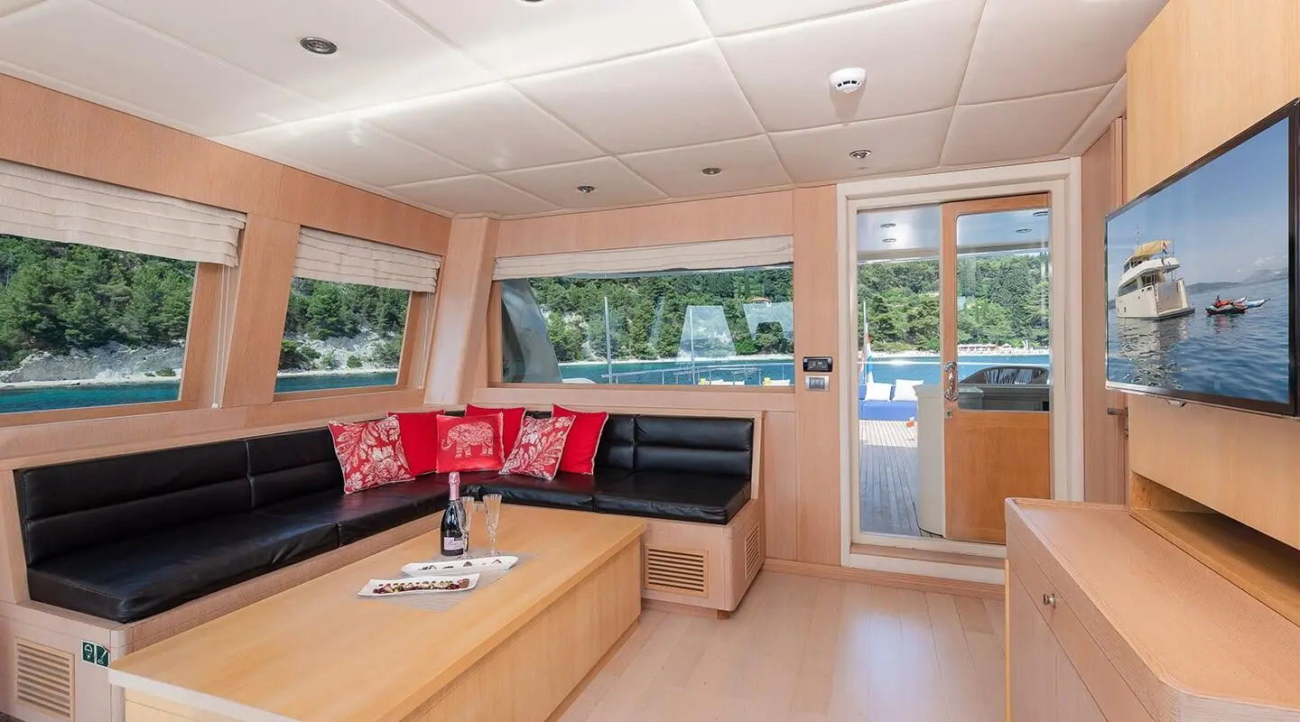 Luxurious yacht Grace interior: spacious salon with seating, wooden accents, large windows