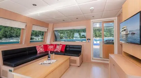 Luxurious yacht Grace interior: spacious salon with seating, wooden accents, large windows