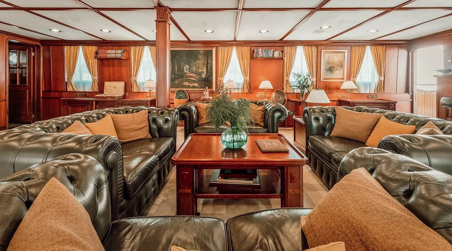 Seagull II luxury saloon with leather Chesterfield sofas and wooden coffee table