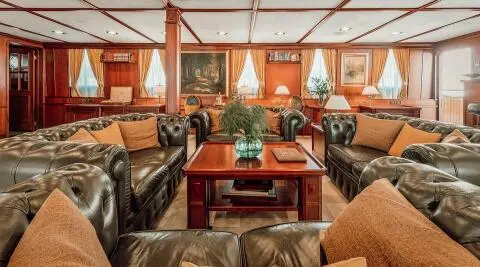 Seagull II luxury saloon with leather Chesterfield sofas and wooden coffee table