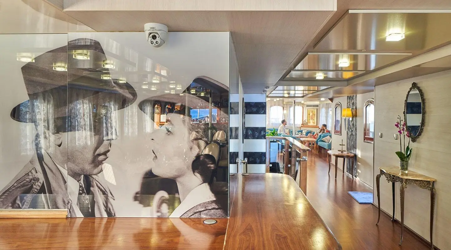 Indoor lounge area with a large black-and-white mural on the wall
