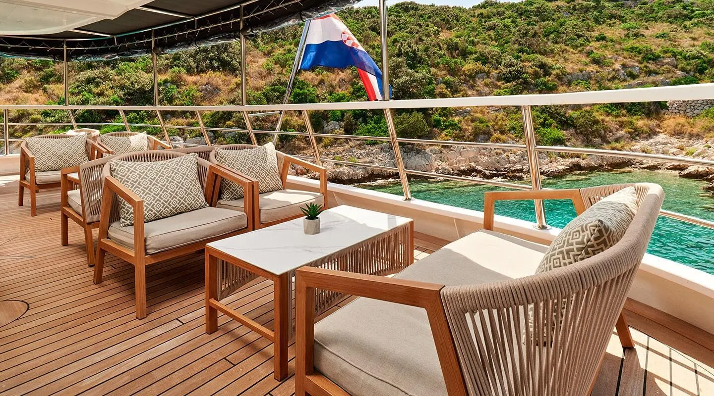Lupus Mare yacht lounge area with cushioned seating and small tables