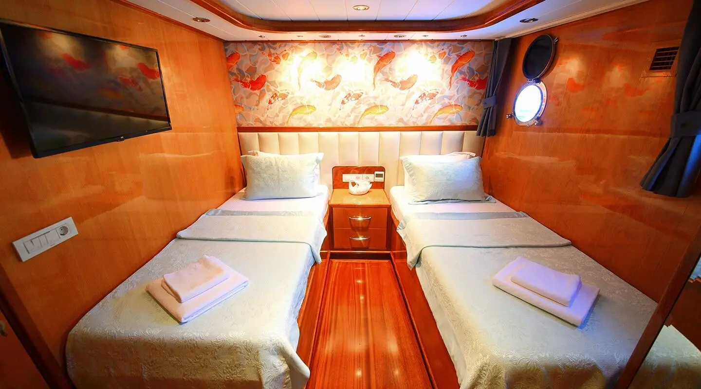 Luxurious yacht Maya interior with cushioned seating along wooden floor and patterned wall