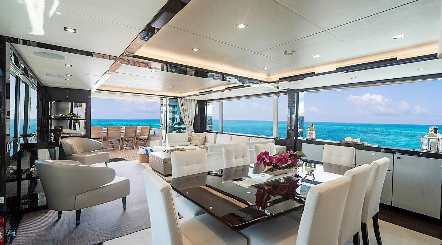 Quantum yacht interior: bright salon with glass dining table and ocean view