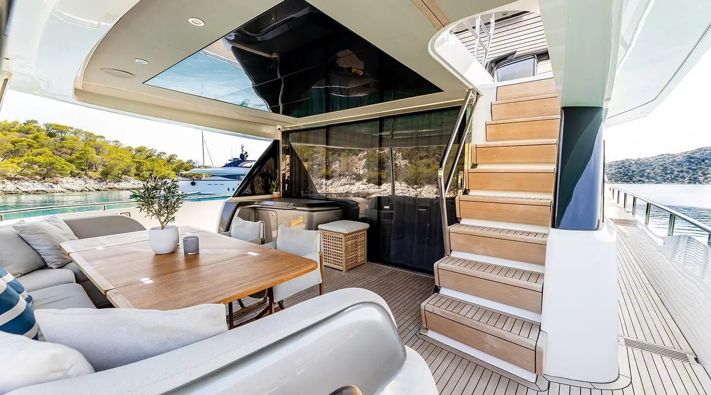 Vista yacht exterior deck with stairs, seating area, and shaded helm space