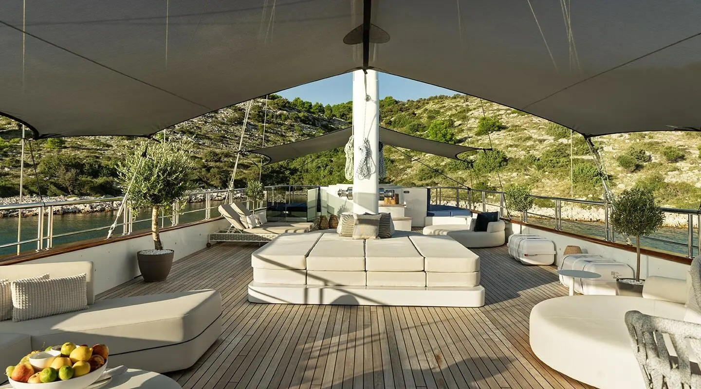 Maxita motoryat sundeck with seating area and shaded lounge, daytime