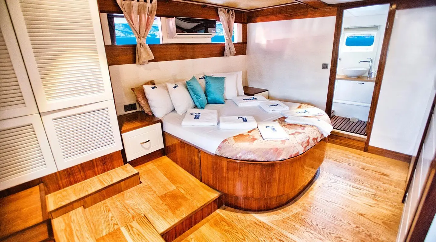 Maske 2 luxury gulet yacht deck with sunbeds and seating under shaded awning at sunset