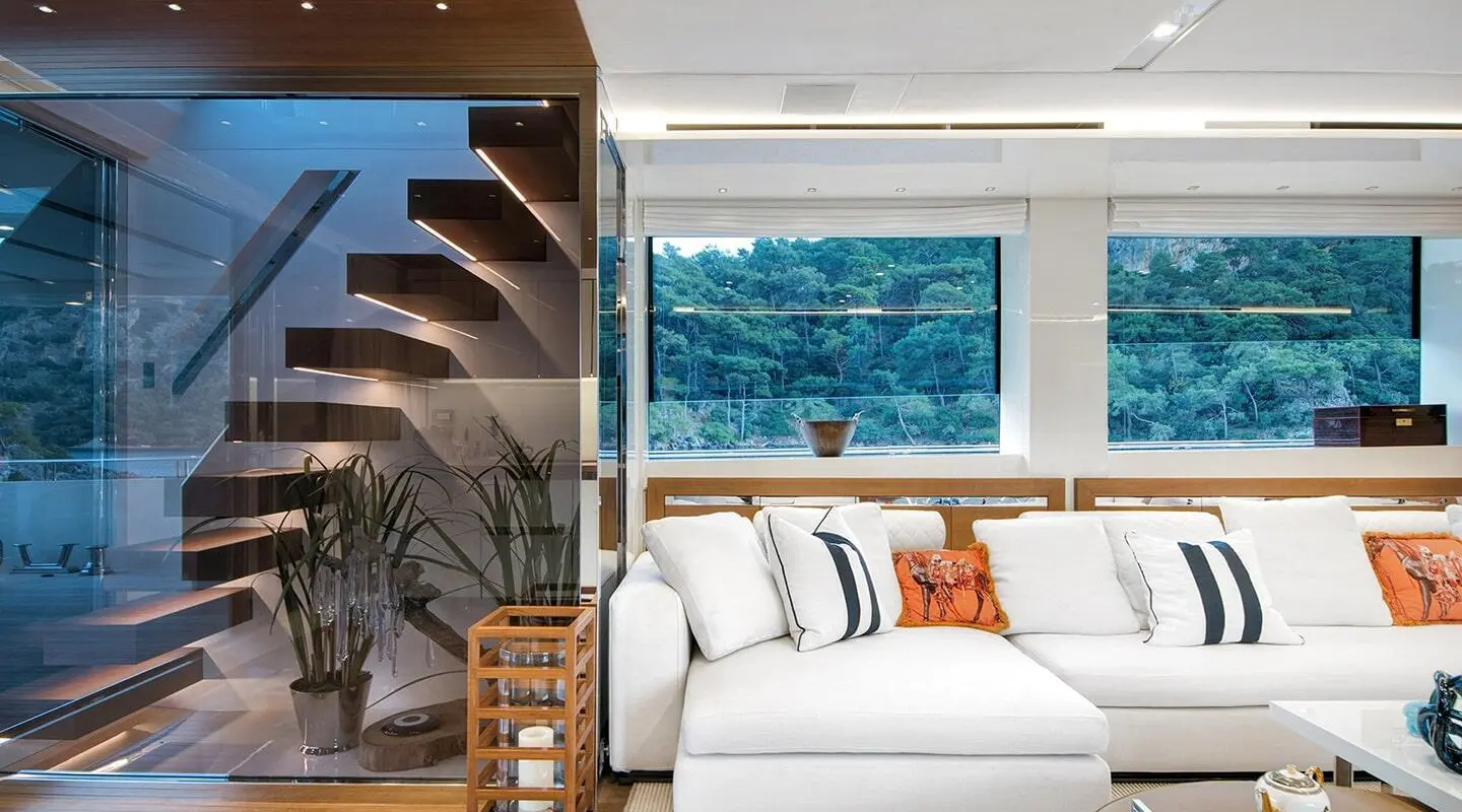 Morning Star yacht saloon interior with white cushioned seating and orange accent pillow