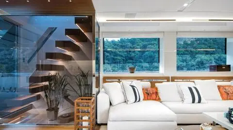 Morning Star yacht saloon interior with white cushioned seating and orange accent pillow