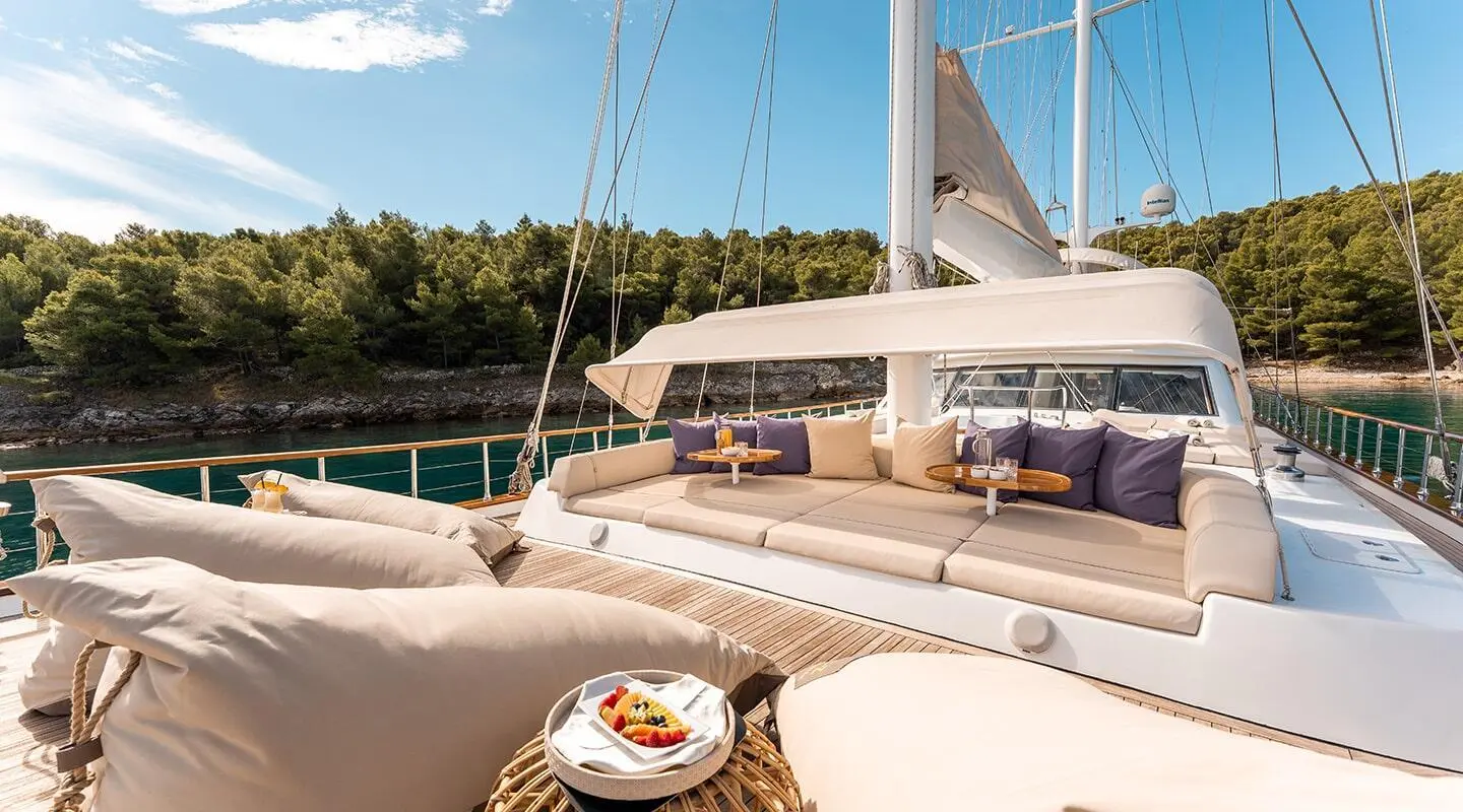 Alessandro I yacht deck at sunset with loungers, white canopy, and railing