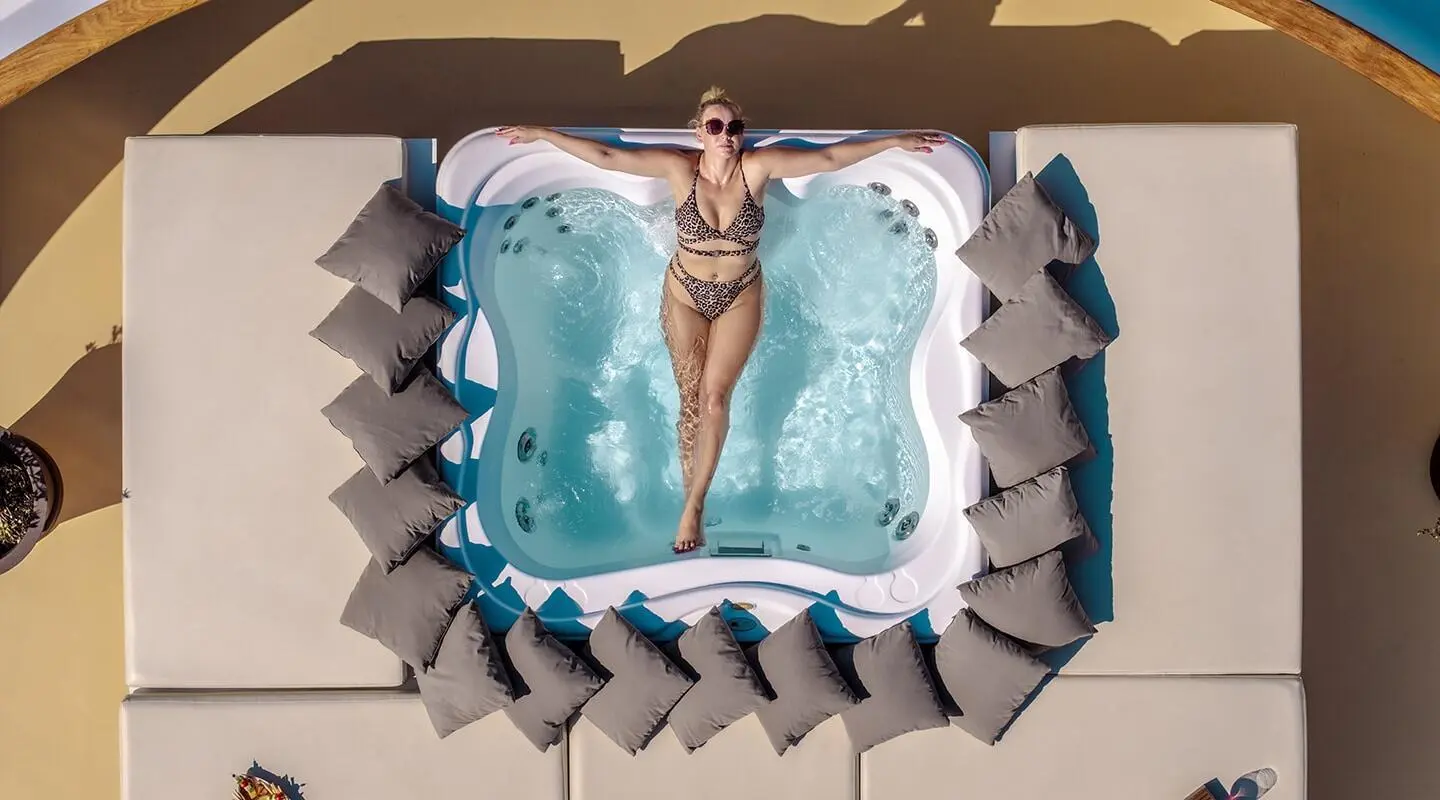 Karizma motor yacht with a hot tub on deck and surrounding loungers
